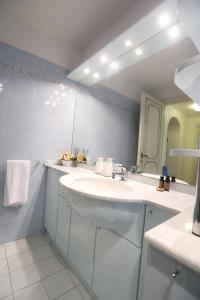 a white bathroom with a sink and a mirror at Maison B in Prato