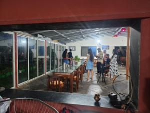 a group of people standing around a table in a restaurant at Shantubaug in Satara