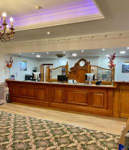 a large courtroom with a large wooden reception desk at Royal Bath Hotel Bournemouth in Bournemouth