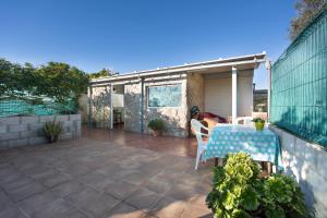 a patio with a table and chairs on it at Mobile Home Manoli in Chiclana de la Frontera +15 photos