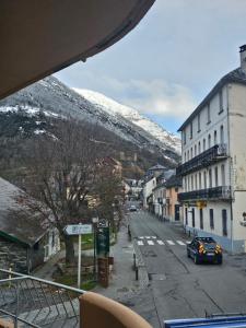 a view of a city street with a snow covered mountain at Évasion à Luz in Luz-Saint-Sauveur