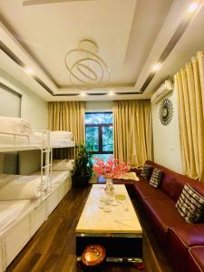 a room with two bunk beds and a couch at Mây Homestay in Cao Bằng in Cao Bằng