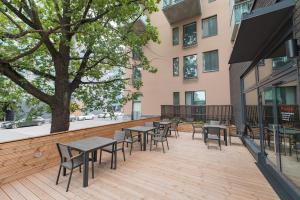 a patio with tables and chairs on a building at Forenom Serviced Apartments Vantaa Neilikkatie in Vantaa