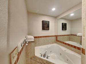 a large bathroom with a tub and a sink at Wonderland Cove in Dandridge