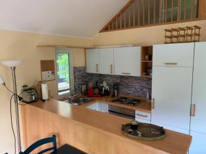 a kitchen with white cabinets and a counter top at Ferienhaus Loubier Marne in Marne +8 photos