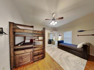 a bedroom with a bunk bed and a ceiling fan at Wonderland Cove in Dandridge