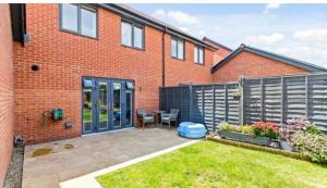 a brick house with a patio in the yard at Folkestone 3 Bedroom home just off M20 in central area private parking in Kent