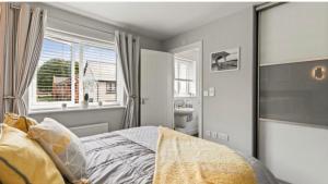 a bedroom with a bed and a window and a sink at Folkestone 3 Bedroom home just off M20 in central area private parking in Kent