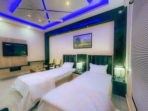 Ένα ή περισσότερα κρεβάτια σε δωμάτιο στο Hotel Blue Bird, North Lakhimpur