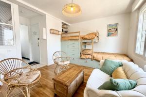 a living room with a couch and a bunk bed at Lovely ! T2 neuf Archi Cosy - Plein bourg in Larmor-Plage +14 photos