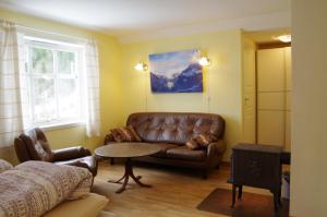 a living room with a couch and a table at Lunheim in Geiranger in Geiranger