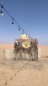 a sign in the middle of the desert at عزبة العاصفة in Al Raka
