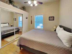 a bedroom with two beds and a mirror at Wonderland Cove in Dandridge +11 photos