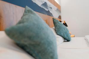 two pillows sitting on top of a couch at Hotel & Appartements Nice Garni in Ichenhausen