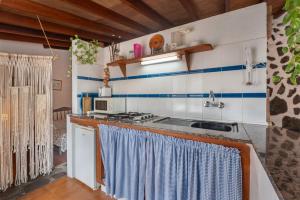 a kitchen with a sink and a stove at Casa Rural La Cuadra in Hermigua