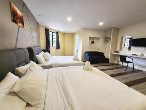 Ένα ή περισσότερα κρεβάτια σε δωμάτιο στο Gohtong Jaya Family Room 5min to Genting Outlet