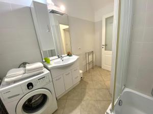 a bathroom with a washing machine and a sink at Gli ulivi della Monda in Finale Ligure