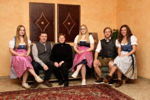 grupa ludzi siedzących na ławce w obiekcie Berghotel Lämmerhof w mieście Sankt Martin am Tennengebirge