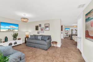 a living room with a couch and a chair at Dreamers Hideaway I Waterfront I Direct Access in Naples