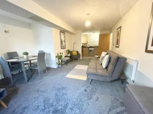 a living room with a couch and a table at Cosy Stays in Ashford Large 2 Bedroom Apartment in Kennington