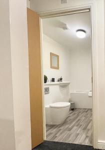 a bathroom with a white toilet in a room at Cosy Stays in Ashford Large 2 Bedroom Apartment in Kennington +5 photos