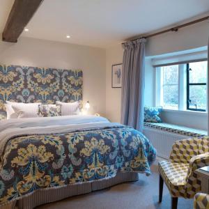 a bedroom with a large bed and a window at The Bear Of Rodborough Hotel in Stroud