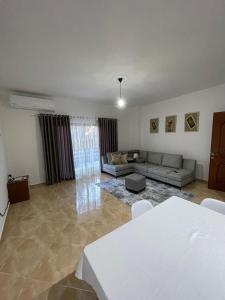 a living room with a couch and a table at KEDA's-Guesthouse in Pogradec