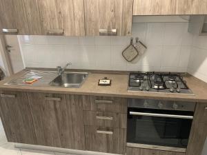 a kitchen with a sink and a stove at Zar in Omegna