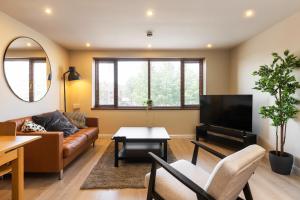 a living room with a couch and a tv at The Van Gogh - Unique 1 bd -Gold Short Term Stays in Belfast