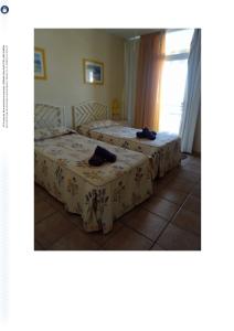 En eller flere senge i et værelse på Marina Palace Vista piscina