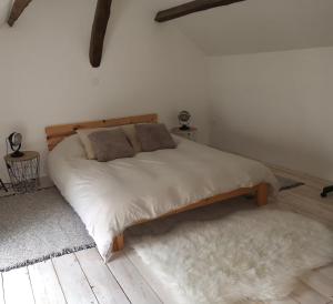 a bedroom with a large bed with two pillows on it at Meulière de Charme in Maincy +13 photos
