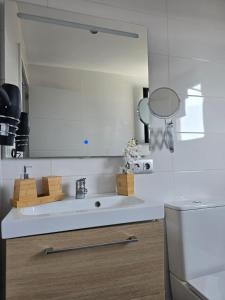 a kitchen with a sink and a mirror at The Blue Calla in Las Palmas de Gran Canaria +16 photos