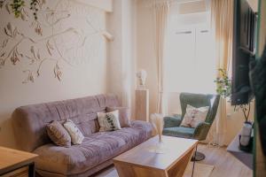 a living room with a couch and two chairs at Angelina Art in Trnava