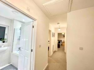 a bathroom with a walk in shower and a sink at Hazel house new 4 bedroom home in Ashford in Ashford