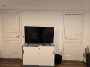 a flat screen tv sitting on top of a white cabinet at Beautiful 2 rooms apartment in kløfta,near oslo airport& oslo in Klofta