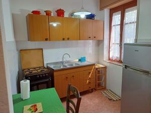 a small kitchen with a sink and a stove at Casa Vacanze Alta Marea T in Teulada