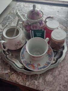 a tea set on a tray with a tea pot and a cup at Moza in Trevelin
