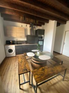 a kitchen with a table and a counter top at Les Pichies, T3 Django, Digoin in Digoin