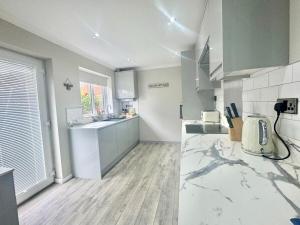 a kitchen with a sink and a counter at Lovely modern 4 bedroom House in Ashford in Ashford