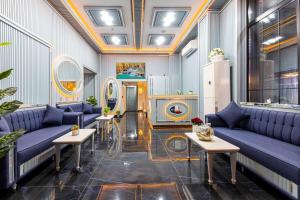 a lobby with blue couches and tables in a building at Santa Rio Gold Taxim Hotel in Istanbul