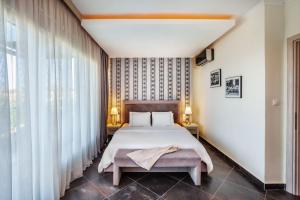 a bedroom with a bed and a large window at Sunny Villa Epta in Hanioti +18 photos