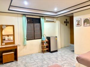 a room with a refrigerator and a table at Sea Sun Bungalow in Ko Lanta