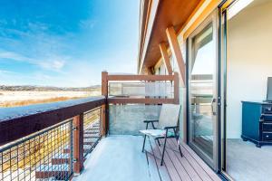 a balcony with a chair and a view of the desert at Newpark Townhomes 28 in Park City