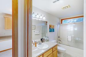 a bathroom with a sink and a toilet and a shower at KC's Serenity By The Sea in Warrenton +23 photos