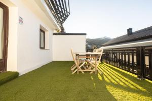 Un patio con una mesa y sillas en un balcón. en SYRA junto al CARD, en Sierra Nevada