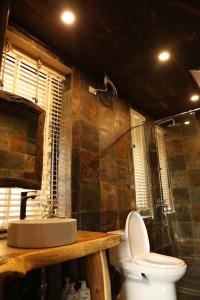 a bathroom with a toilet and a shower and a sink at Quin home, into the forest, close to Noi Bai airport in Phú Hữu