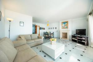 a living room with a couch and a tv at Can Vidal Des Port de Pollensa in Port de Pollensa