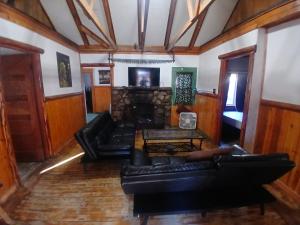a living room with leather couches and a fireplace at Cabin 33, 3 bedroom 2 bath in Big Bear Lake