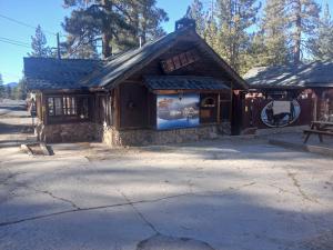 a wooden building with a sign in front of it at Cabin 33, 3 bedroom 2 bath in Big Bear Lake