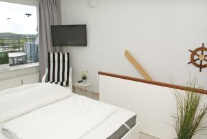 Μια τηλεόραση ή/και κέντρο ψυχαγωγίας στο Penthousewohnung mit WLAN - Ostseeblick zur Sonnenseite +11 φωτογραφίες